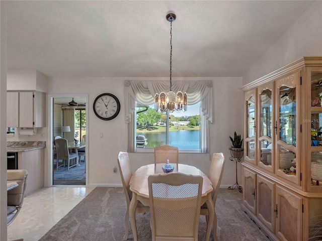 dining room with baseboards and a notable chandelier