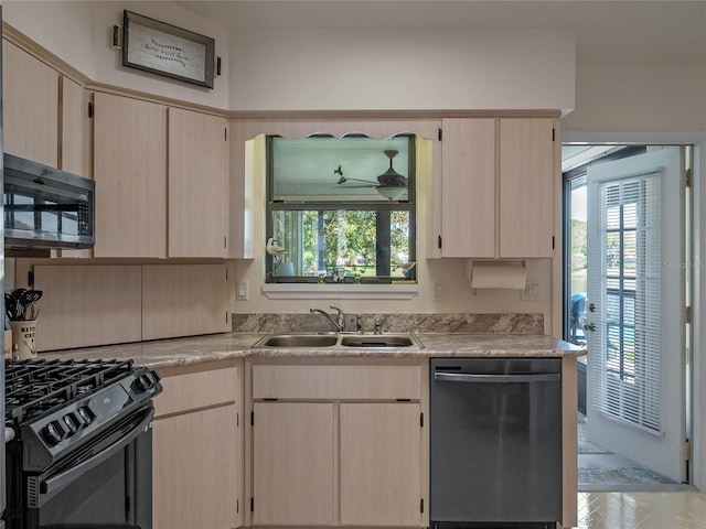 kitchen with light brown cabinetry, a sink, stainless steel dishwasher, black gas range oven, and light countertops