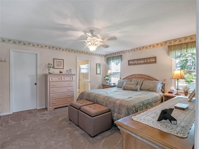 bedroom featuring connected bathroom, carpet, and ceiling fan