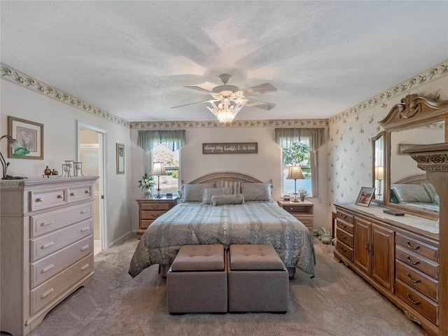 bedroom featuring light colored carpet, wallpapered walls, a textured ceiling, and multiple windows