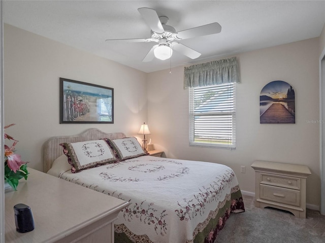 carpeted bedroom featuring baseboards and ceiling fan