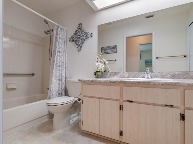 full bathroom featuring visible vents, toilet, a skylight, shower / tub combo, and vanity