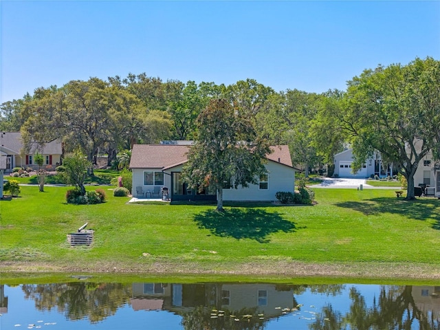 rear view of property with a yard and a water view