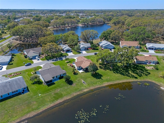 bird's eye view with a forest view, a water view, and a residential view