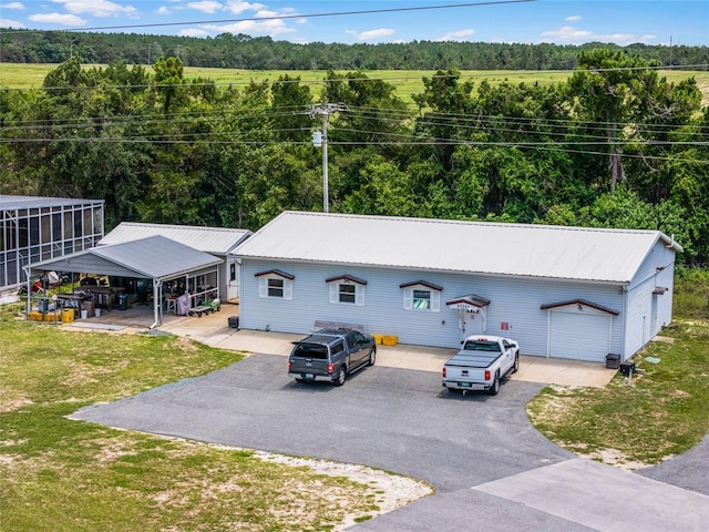 bird's eye view with a wooded view