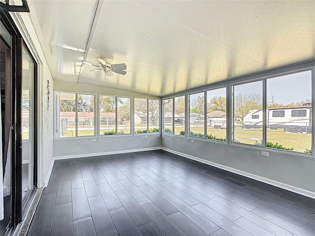 unfurnished sunroom featuring lofted ceiling and ceiling fan