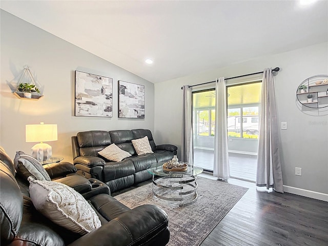 living area with dark wood finished floors, lofted ceiling, and baseboards