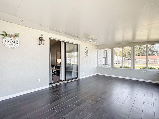 unfurnished sunroom with plenty of natural light and a ceiling fan