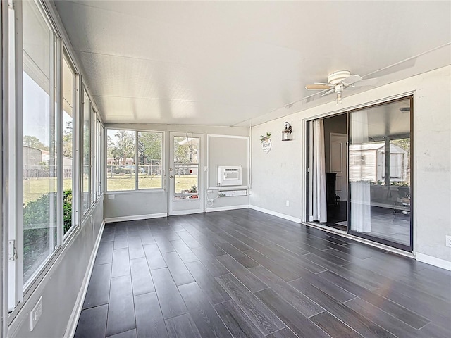 unfurnished sunroom featuring ceiling fan