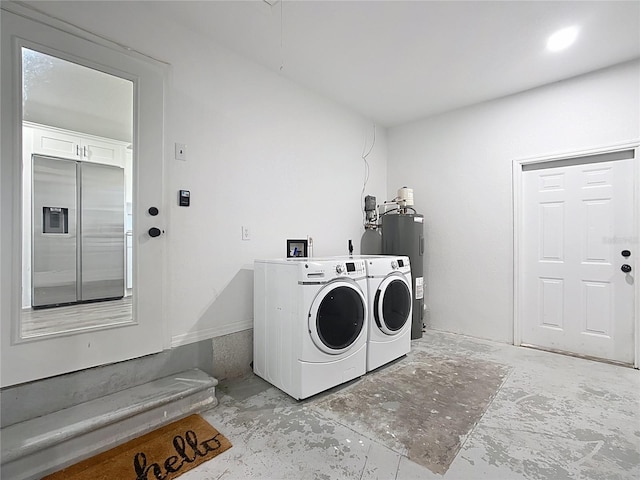 clothes washing area with electric water heater, washing machine and dryer, and laundry area