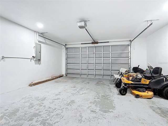 garage with electric panel and a garage door opener