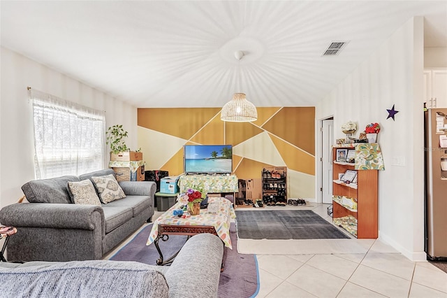 living room featuring baseboards, visible vents, and tile patterned floors