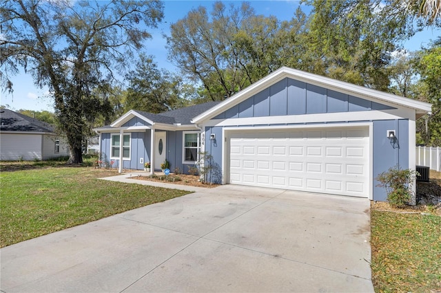 single story home featuring concrete driveway, an attached garage, board and batten siding, a front yard, and central AC