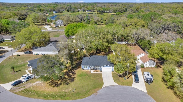 birds eye view of property featuring a view of trees