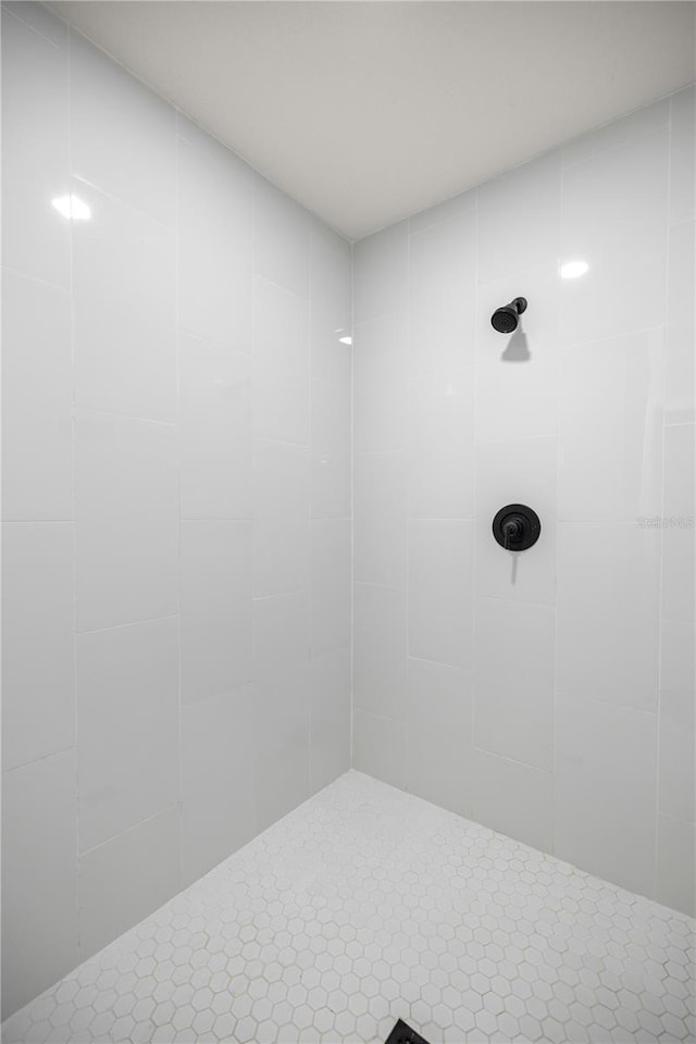 full bath with a tile shower