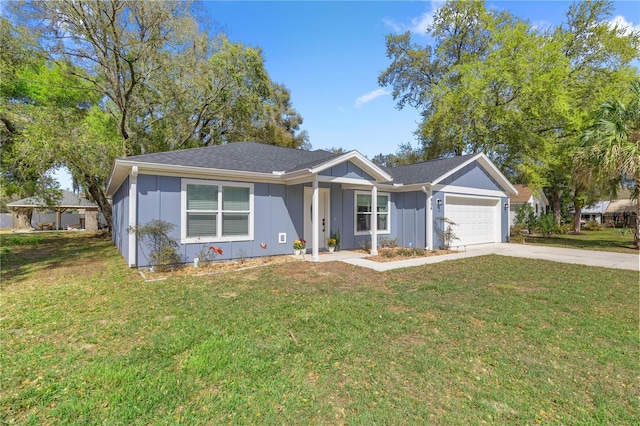 single story home featuring a garage, a front yard, board and batten siding, and concrete driveway