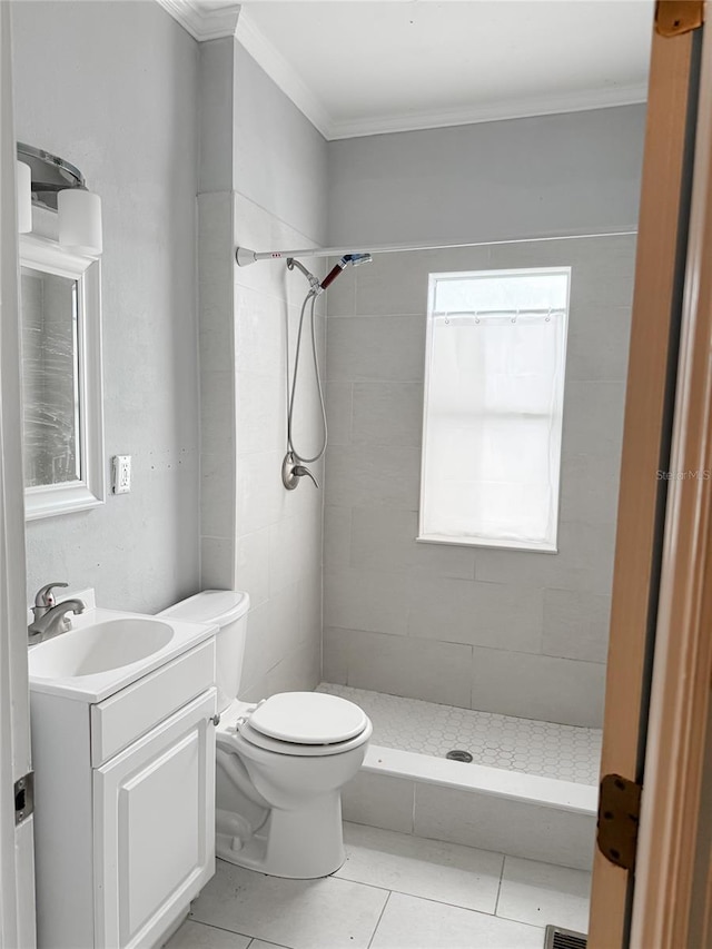 full bathroom featuring toilet, ornamental molding, a shower stall, vanity, and tile patterned floors