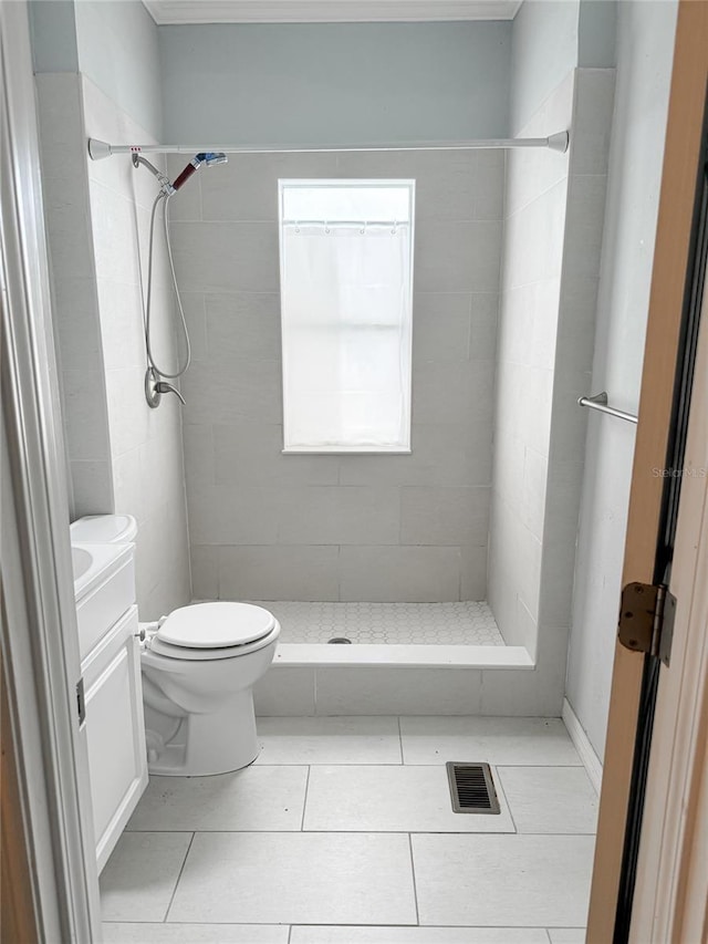 full bathroom with visible vents, toilet, a stall shower, vanity, and tile patterned flooring