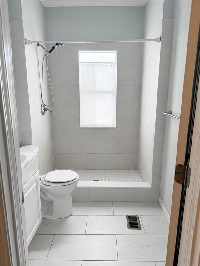 bathroom with visible vents, toilet, a stall shower, vanity, and tile patterned flooring