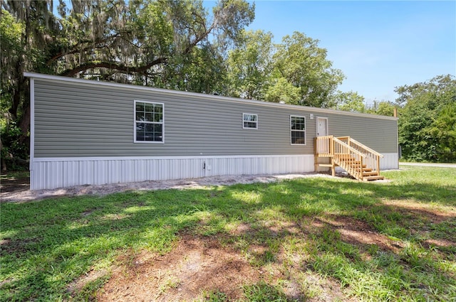 rear view of property with a yard