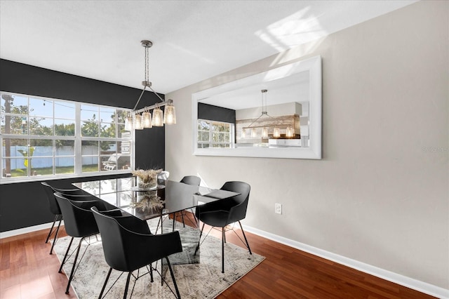 dining room with baseboards and wood finished floors