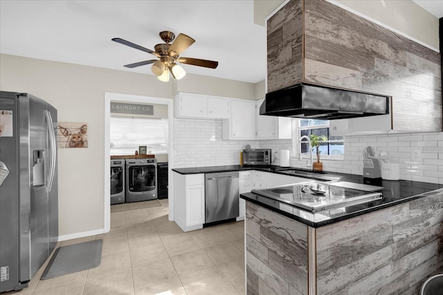 kitchen featuring washer and dryer, dark countertops, white cabinetry, appliances with stainless steel finishes, and decorative backsplash