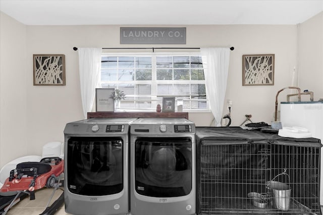 laundry area featuring tile patterned floors, laundry area, and washer and clothes dryer