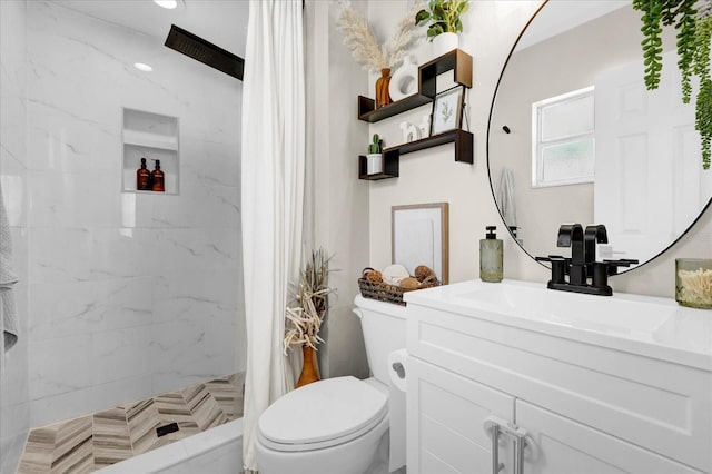 bathroom with toilet, a stall shower, and vanity