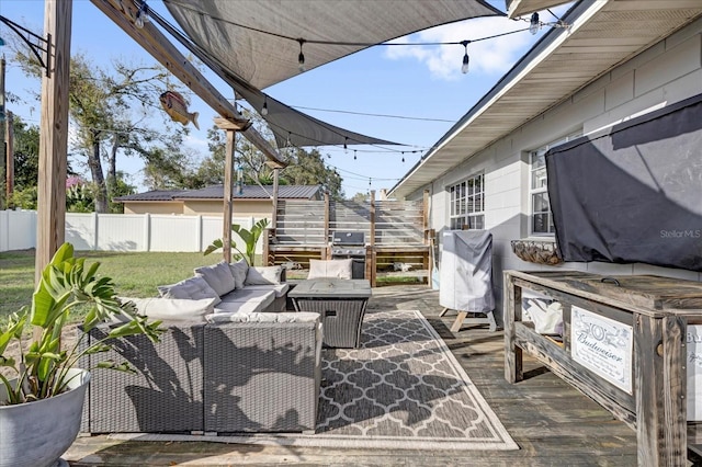 view of patio with an outdoor living space, fence, and grilling area