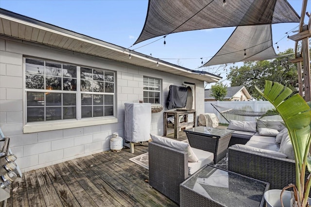 wooden terrace with outdoor lounge area and fence