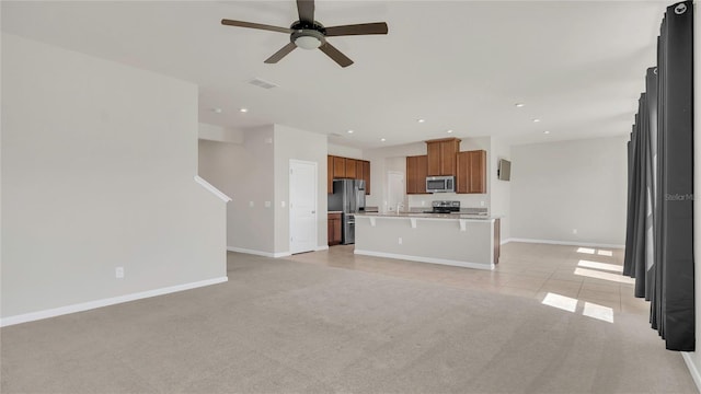 unfurnished living room featuring recessed lighting, a ceiling fan, baseboards, and light carpet