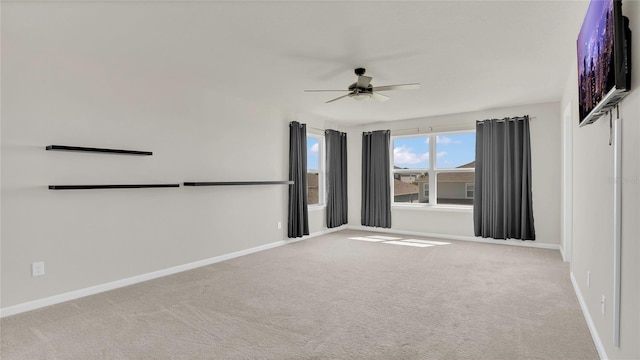 unfurnished room with baseboards, a ceiling fan, and carpet floors