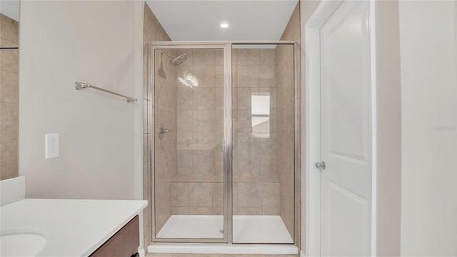 bathroom with recessed lighting, a shower stall, and vanity