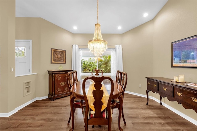 dining area featuring an inviting chandelier, recessed lighting, baseboards, and wood finished floors