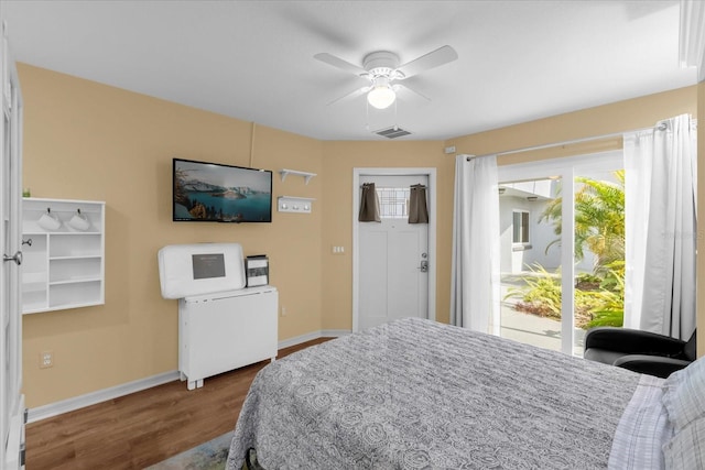 bedroom featuring a ceiling fan, wood finished floors, baseboards, and visible vents