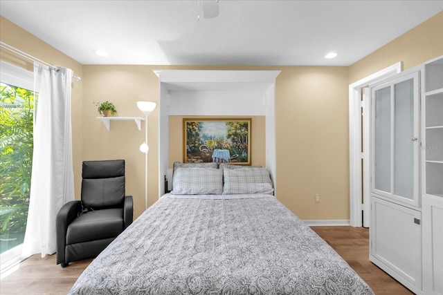 bedroom with recessed lighting, baseboards, and wood finished floors