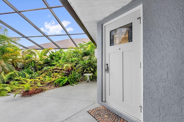 doorway to property with stucco siding and a patio