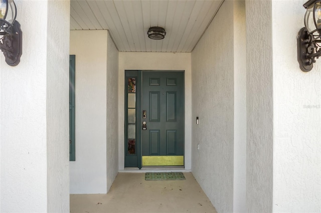 doorway to property with stucco siding