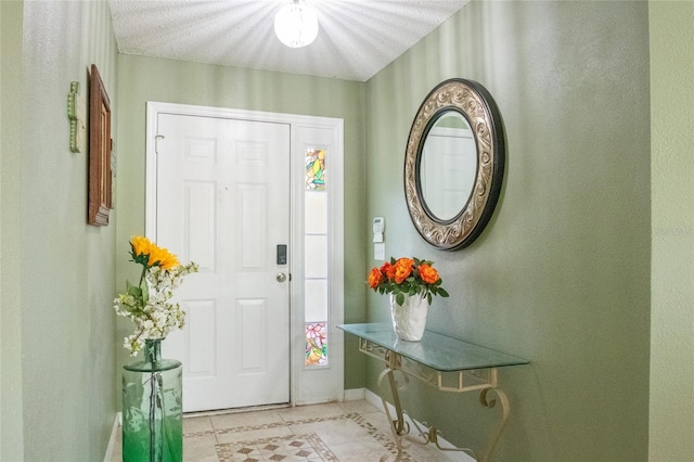 entryway featuring a textured ceiling and baseboards