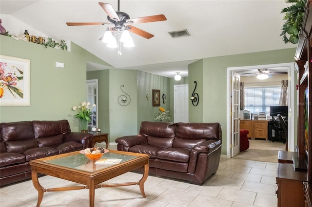 living room featuring light tile patterned floors, visible vents, a ceiling fan, and vaulted ceiling