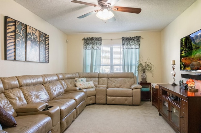 living area with light colored carpet, a textured ceiling, and a ceiling fan