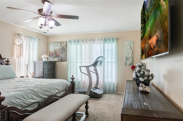 bedroom with carpet flooring, a textured ceiling, and ceiling fan