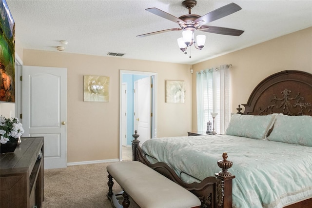 bedroom with visible vents, baseboards, carpet, a textured ceiling, and a ceiling fan