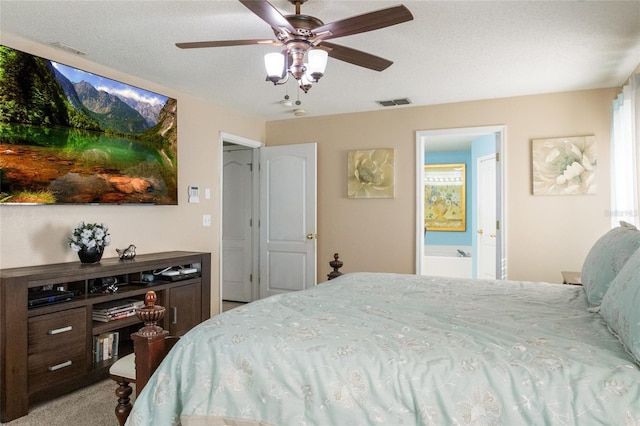 bedroom featuring visible vents, ceiling fan, a textured ceiling, carpet flooring, and connected bathroom