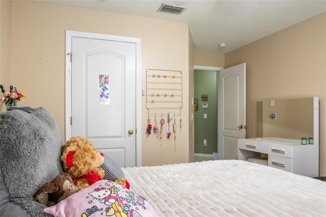 bedroom with visible vents and a textured ceiling