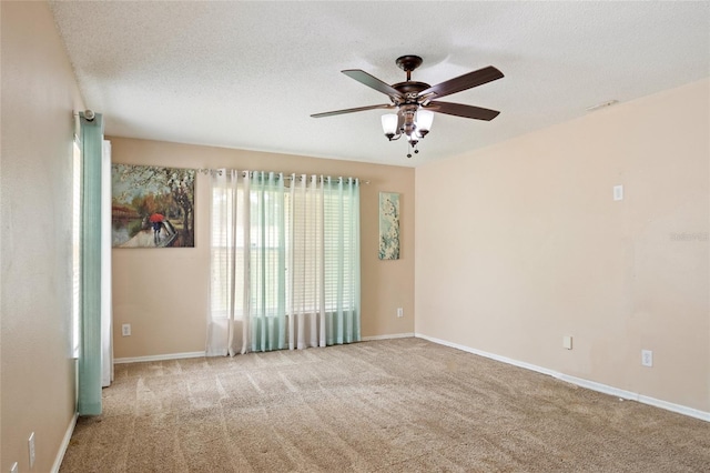 unfurnished room featuring baseboards, ceiling fan, and carpet floors