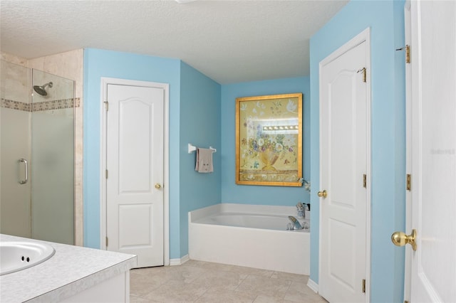 bathroom with vanity, a textured ceiling, baseboards, a shower stall, and a garden tub