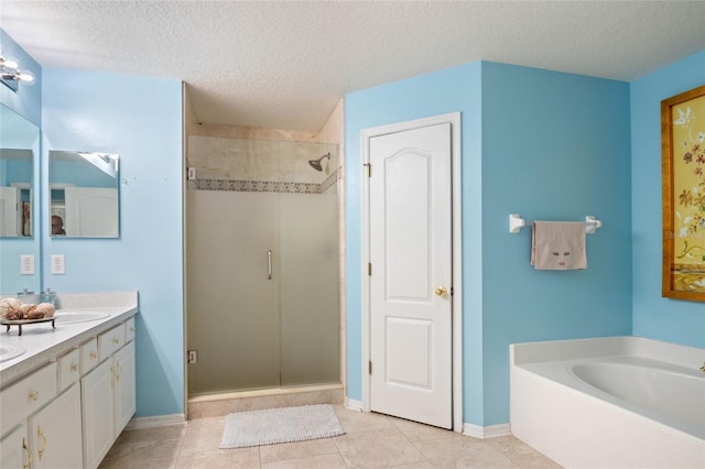 bathroom featuring double vanity, a garden tub, a textured ceiling, tile patterned flooring, and a shower stall
