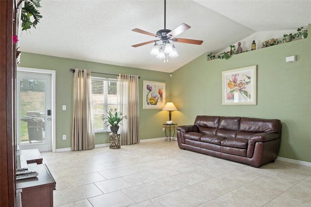 living room with vaulted ceiling, baseboards, a ceiling fan, and light tile patterned floors