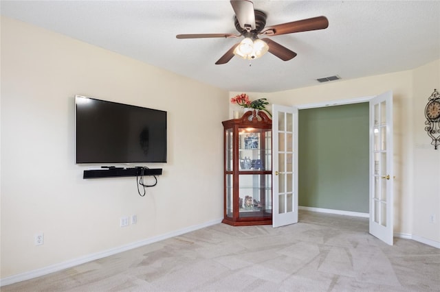 unfurnished living room featuring french doors, visible vents, ceiling fan, carpet flooring, and baseboards